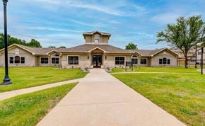 Cedar Hill townhouse for rent - the front of a building with a sidewalk and grass