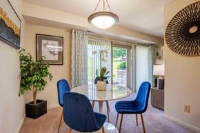 Owings Mills townhouse for rent - a dining room with a table and chairs and a window