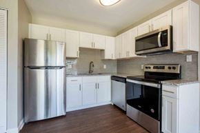 Owings Mills townhouse for rent - a kitchen with stainless steel appliances and white cabinets