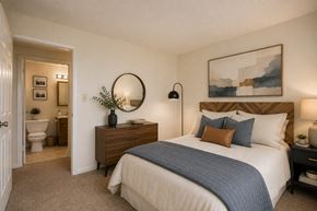 Owings Mills townhouse for rent - A bedroom with a large bed and a mirror on the wall.