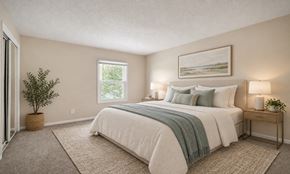 Tampa townhouse for rent - A bedroom with a large bed and a potted plant.