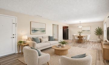 Tampa townhouse for rent - A living room with a couch, chairs, and a painting on the wall.