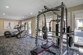 Lafayette apartment for rent - A home gym with a treadmill, weights, and a bench.