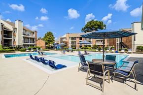 Lafayette apartment for rent - A pool area with chairs and a table.