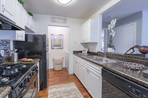Miamisburg apartment for rent - a kitchen with granite counter tops and black appliances