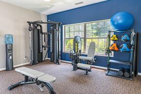 Miamisburg apartment for rent - a gym with weights and equipment in a room with a window