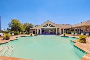 Shreveport apartment for rent - a swimming pool with a house in the background