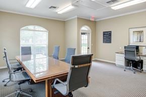 Shreveport apartment for rent - a conference room with a wooden table and chairs