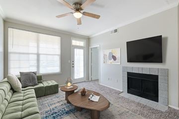 Shreveport apartment for rent - a living room with a ceiling fan and a television