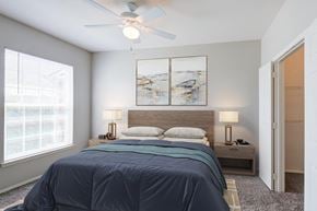 Shreveport apartment for rent - a bedroom with a bed and a ceiling fan