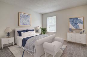 Concord apartment for rent - A bedroom with a white bed, a white chair, and a white nightstand.