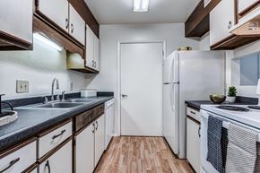 Concord apartment for rent - A kitchen with white appliances and wooden cabinets.