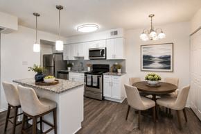 Olney apartment for rent - A kitchen with a table and chairs and a painting on the wall.