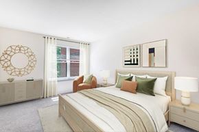 Olney apartment for rent - a bedroom with a bed and a chair and a window