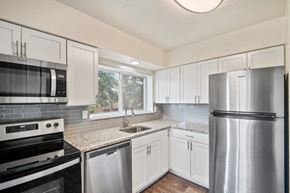 Cockeysville apartment for rent - a kitchen with stainless steel appliances and white cabinets