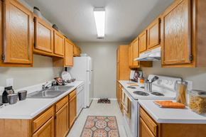 Augusta apartment for rent - a kitchen with white appliances and wooden cabinets
