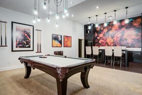 Tampa apartment for rent - a games room with a pool table and a dining area