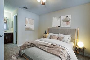 Tampa apartment for rent - a bedroom with a large bed and a mirror