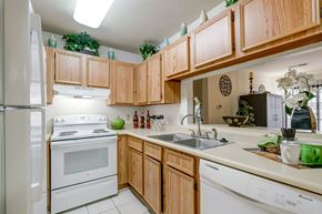 Aiken apartment for rent - a kitchen with white appliances and wooden cabinets