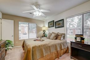 Aiken apartment for rent - a bedroom with a large bed and a ceiling fan
