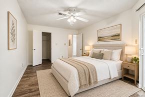 Aiken apartment for rent - A bedroom with a large bed and a ceiling fan.