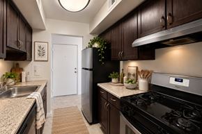 Glen Burnie townhouse for rent - A kitchen with a black stove top oven and a white refrigerator.