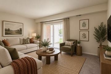 Glen Burnie townhouse for rent - A living room with a couch, chair, and a table with a vase on it.