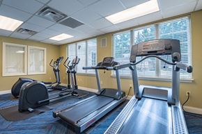 Glen Burnie townhouse for rent - a gym with exercise machines and windows