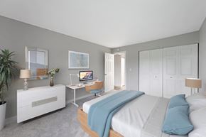 Woodridge apartment for rent - a bedroom with a bed and a desk with a computer