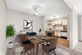 Woodridge apartment for rent - A dining room with a table set for two and a potted plant.