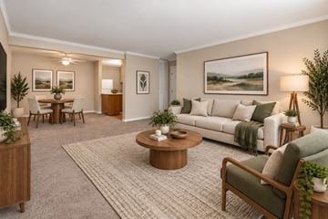 Woodridge apartment for rent - A living room with a white couch, a coffee table, and a painting on the wall.
