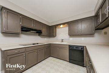 Winter Park house for rent - A kitchen with brown cabinets and a black oven.