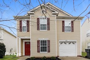 Charlotte house for rent - A two-story house with a red door and garage door.