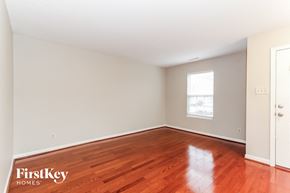 Charlotte house for rent - A room with wooden flooring and a window with a white frame.