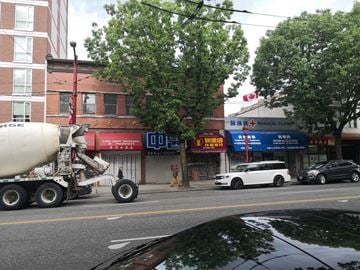 Vancouver apartment for rent - A cement truck is on the street in front of a building with a sign that says "Medical Clinic.".