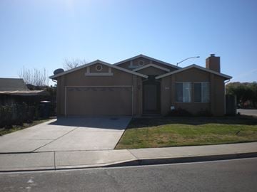 Patterson house for rent - the front of a house with a driveway and a garage door