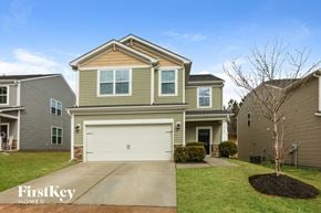 Raleigh house for rent - a tan and green house with a white garage door