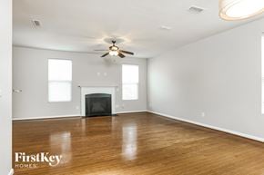 Raleigh house for rent - a living room with a fireplace and a ceiling fan