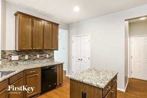 Raleigh house for rent - a kitchen with granite counter tops and wooden cabinets