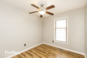Kansas City house for rent - a bedroom with a ceiling fan and a window