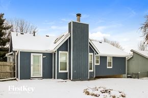 Kansas City house for rent - the exterior of a blue house in the snow