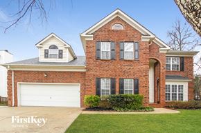 Charlotte house for rent - a brick house with a white garage door in front of it