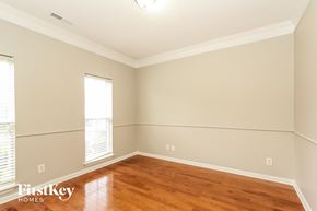 Charlotte house for rent - a living room with wood floors and white walls and a window