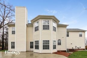 Charlotte house for rent - a yellow house with a tall tower on top of it