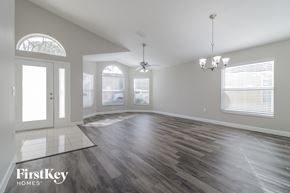 Orlando house for rent - the living room of an empty house with wood floors and a window