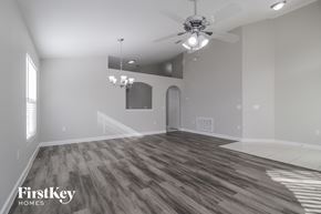 Orlando house for rent - a living room with wood floors and a ceiling fan