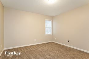 Raleigh house for rent - the spacious living room with carpeting and a window