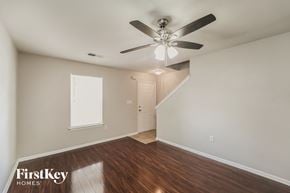 Charlotte house for rent - a living room with wood floors and a ceiling fan