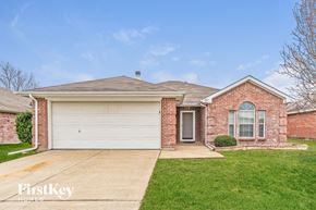 Forney house for rent - a brick house with a white garage door