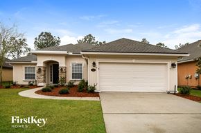 St Augustine house for rent - a beige house with a white garage door
